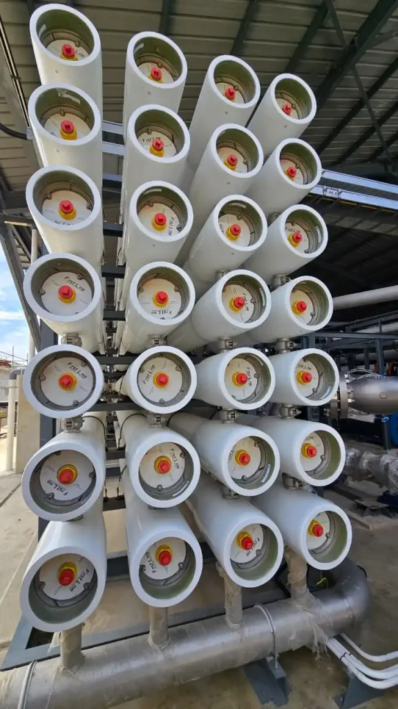 Close-up of the Sea Water Reverse Osmosis (SWRO) membrane racks at the GLS desalination plant, showing rows of white pressure vessels which are the core of the water purification process.
