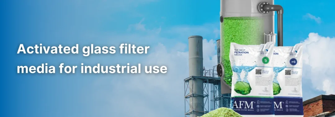 Industrial worker inspecting activated glass filter media for water treatment system in Indonesia.